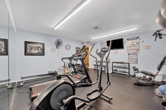 workout area featuring a textured ceiling