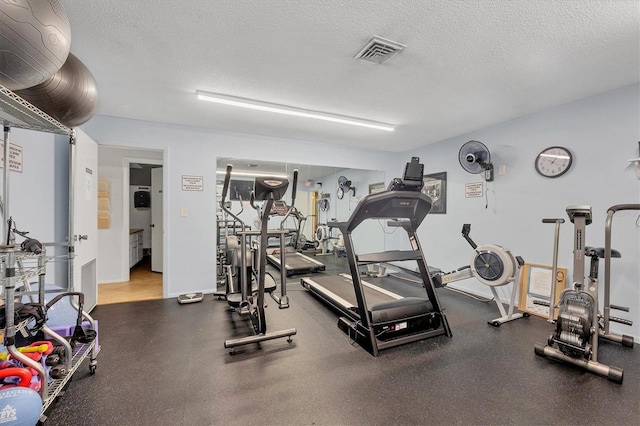 gym with a textured ceiling