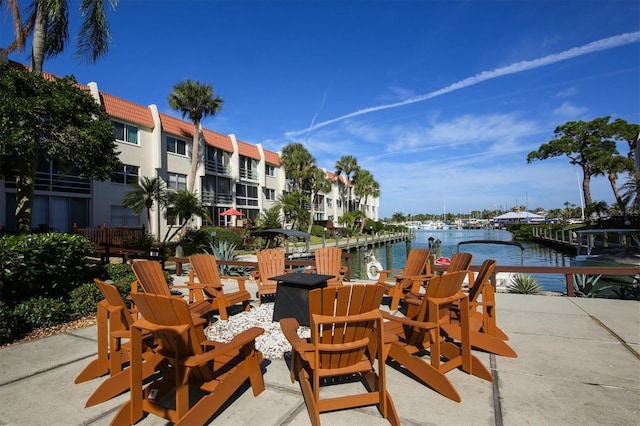 view of patio / terrace with a boat dock and a water view