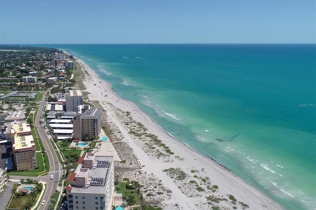 drone / aerial view featuring a beach view and a water view