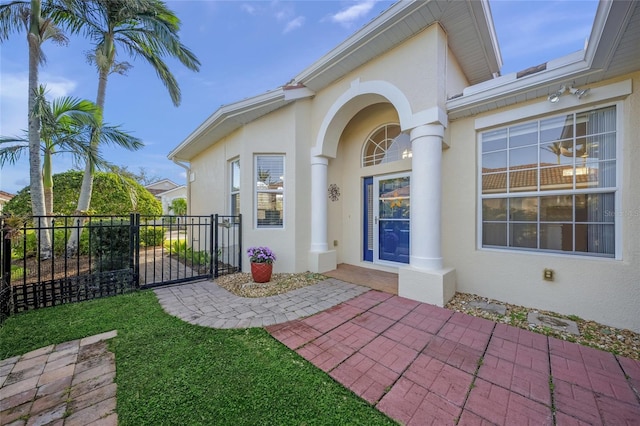 property entrance with a lawn