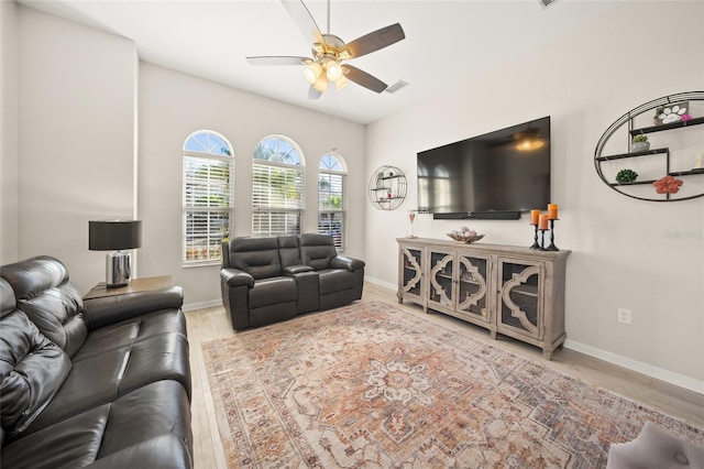 living room featuring light hardwood / wood-style flooring and ceiling fan