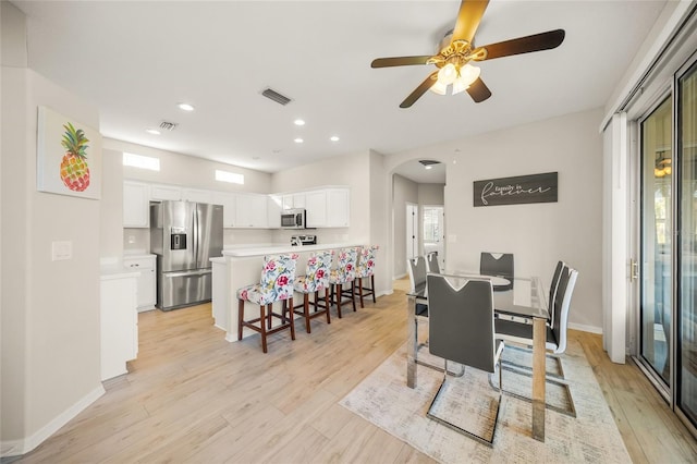 dining space with light hardwood / wood-style flooring and ceiling fan