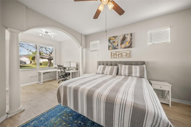 bedroom featuring ornate columns, ceiling fan, and light hardwood / wood-style flooring