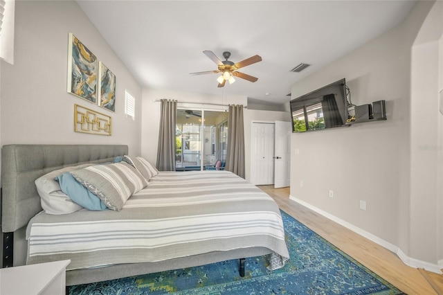 bedroom with hardwood / wood-style flooring, ceiling fan, and access to outside