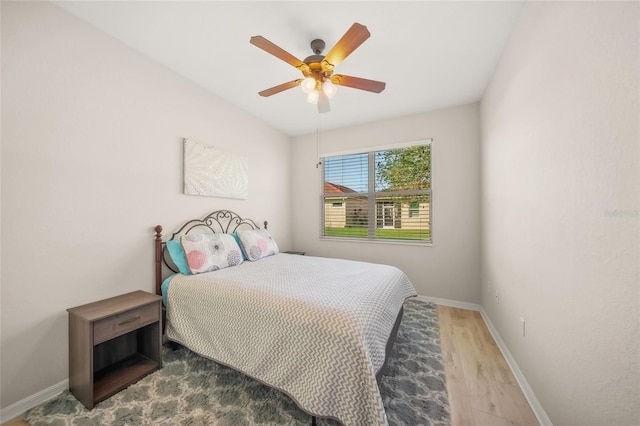 bedroom with ceiling fan and wood-type flooring