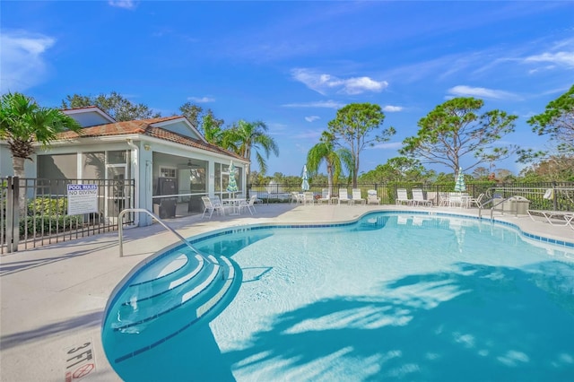 view of pool with ceiling fan and a patio