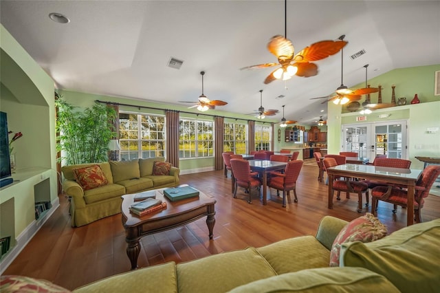 living room with wood-type flooring, lofted ceiling, and french doors