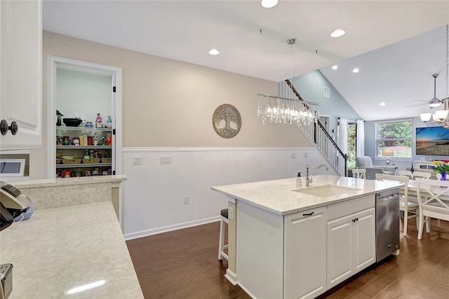 kitchen with sink, hanging light fixtures, dark hardwood / wood-style flooring, a center island with sink, and white cabinets