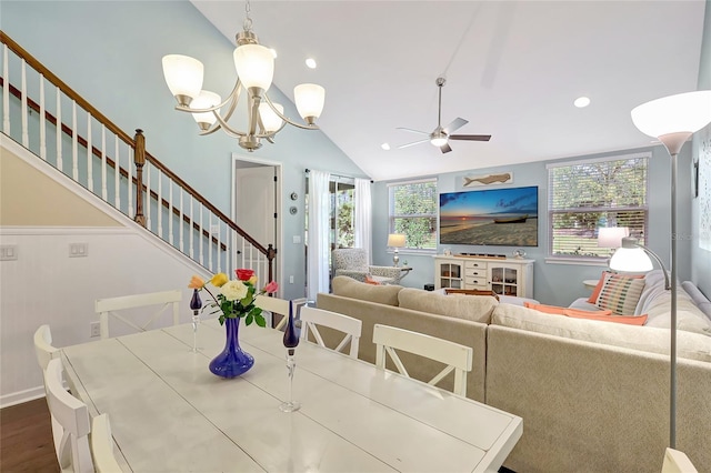 dining area with dark hardwood / wood-style flooring, ceiling fan with notable chandelier, and vaulted ceiling