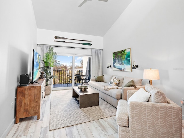 living room with high vaulted ceiling, light hardwood / wood-style flooring, and ceiling fan