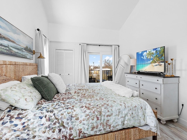 bedroom with access to exterior, light hardwood / wood-style floors, and lofted ceiling