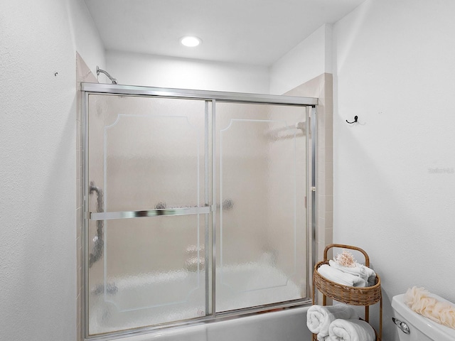 bathroom with toilet and enclosed tub / shower combo