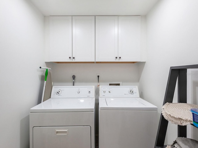 laundry room featuring cabinets and washing machine and dryer