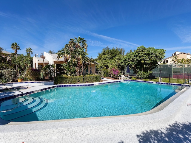 view of swimming pool with a jacuzzi