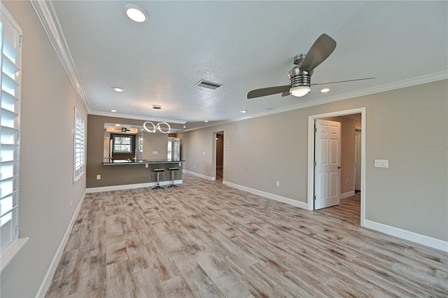 unfurnished living room featuring light hardwood / wood-style floors, ceiling fan, crown molding, and sink