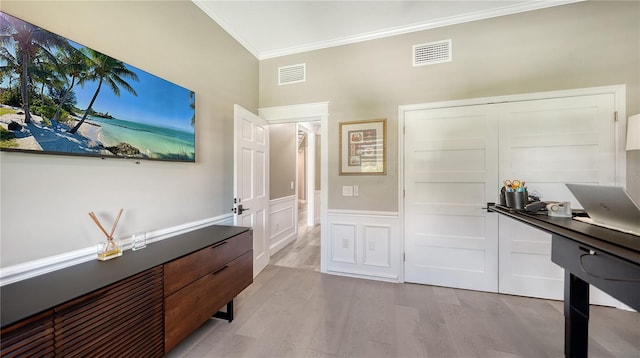 interior space with light hardwood / wood-style floors and ornamental molding