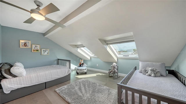 bedroom featuring light hardwood / wood-style floors, ceiling fan, and vaulted ceiling with skylight