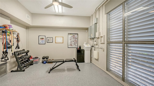 exercise area featuring a ceiling fan, washer / clothes dryer, visible vents, and a textured ceiling