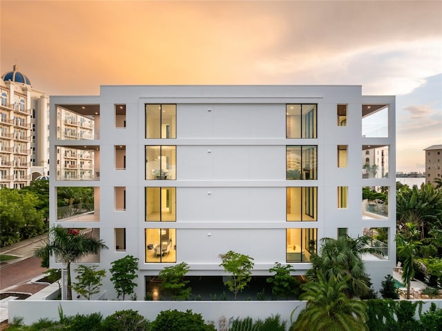 view of outdoor building at dusk