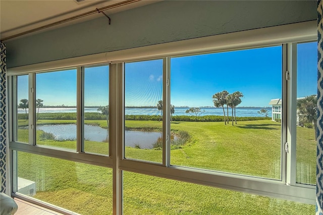 unfurnished sunroom with a water view