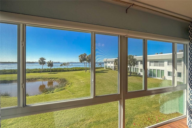 unfurnished sunroom with a water view