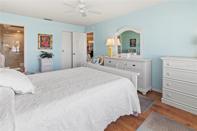 bedroom with ceiling fan, dark hardwood / wood-style flooring, and ensuite bathroom