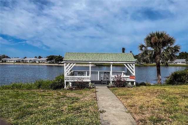 view of front of home featuring a gazebo, a water view, and a front yard