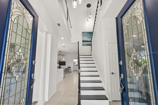 entrance foyer with ceiling fan and light tile patterned floors