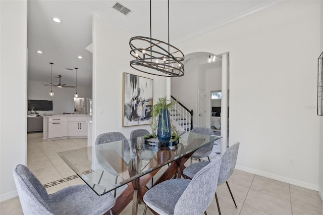 dining area featuring ceiling fan, light tile patterned floors, and crown molding