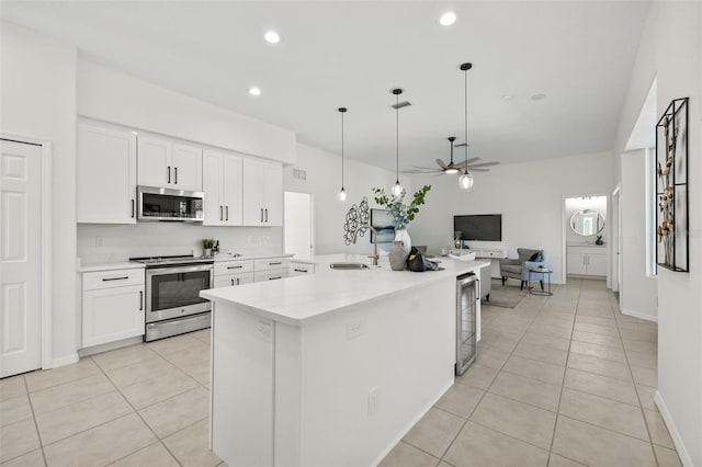 kitchen with white cabinetry, ceiling fan, decorative light fixtures, and appliances with stainless steel finishes