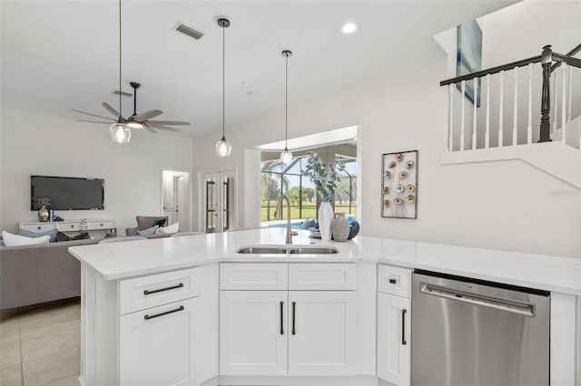 kitchen with sink, stainless steel dishwasher, ceiling fan, light tile patterned floors, and white cabinetry