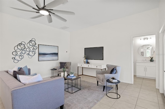 tiled living room featuring ceiling fan and sink