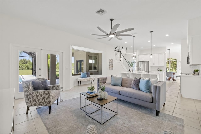 living room with ceiling fan and light tile patterned flooring