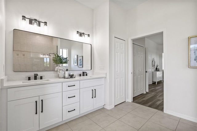 bathroom with a shower, tile patterned flooring, and vanity