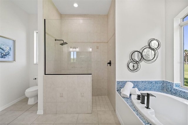 bathroom with tile patterned flooring, a tile shower, and toilet