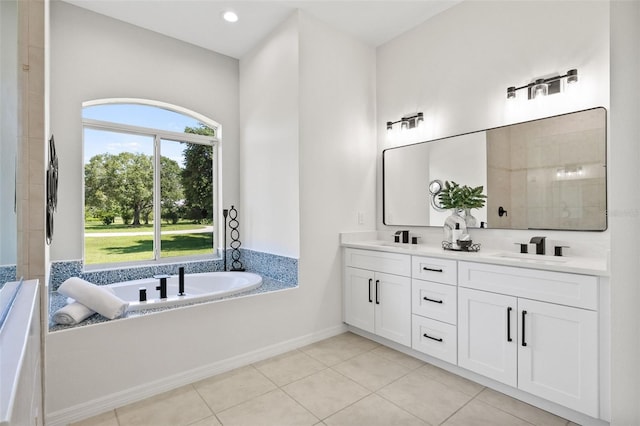 bathroom featuring tile patterned floors, vanity, and a bath