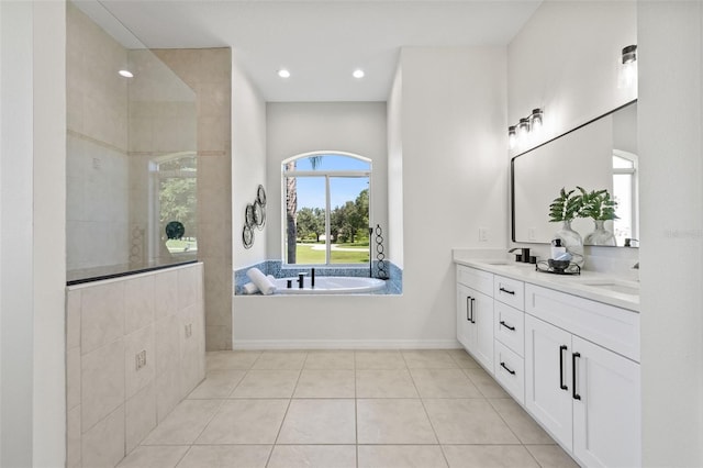 bathroom featuring tile patterned flooring, vanity, and separate shower and tub