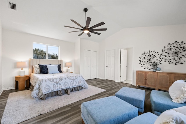 bedroom featuring ceiling fan, a closet, dark wood-type flooring, and vaulted ceiling