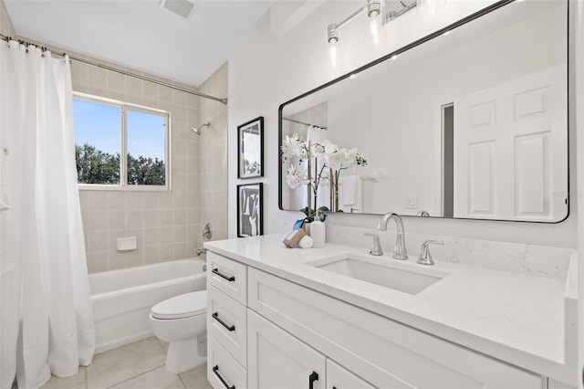 full bathroom featuring toilet, vanity, tile patterned floors, and shower / tub combo with curtain