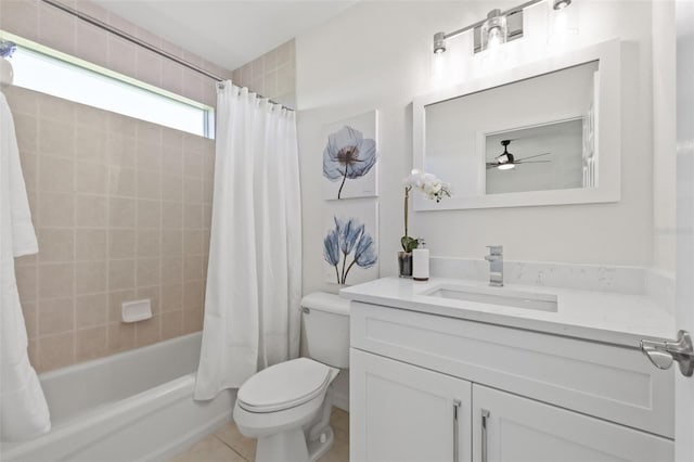 full bathroom featuring vanity, tile patterned flooring, ceiling fan, toilet, and shower / bath combo with shower curtain