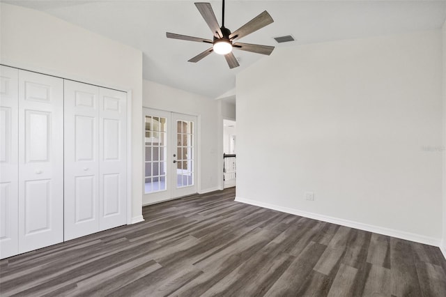 unfurnished bedroom with ceiling fan, french doors, dark wood-type flooring, lofted ceiling, and a closet