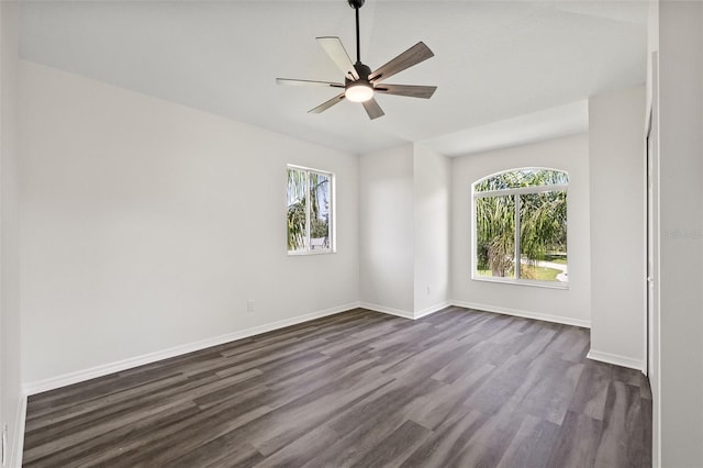 empty room with dark hardwood / wood-style floors and ceiling fan