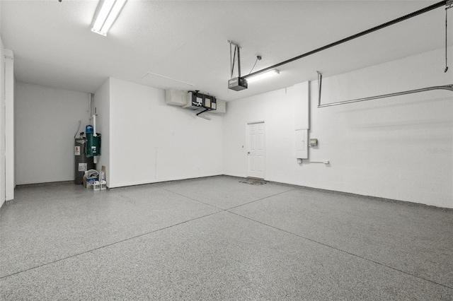 garage with a garage door opener and water heater