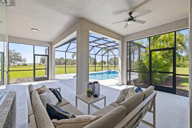 sunroom with a pool and ceiling fan