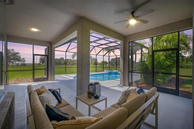 sunroom / solarium with ceiling fan, plenty of natural light, and a pool