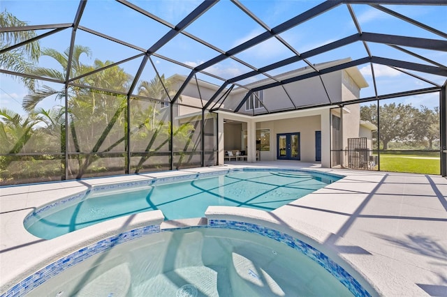 view of pool featuring an in ground hot tub, french doors, glass enclosure, and a patio area