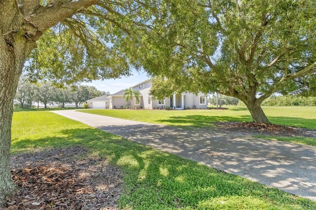 view of front of home with a front lawn and a garage