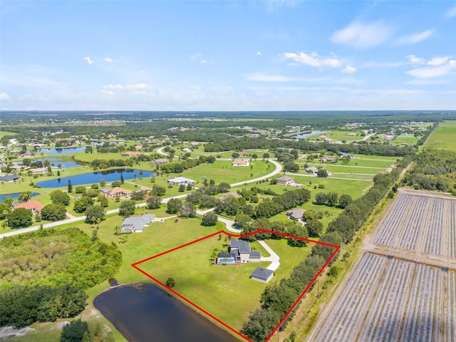 birds eye view of property with a water view