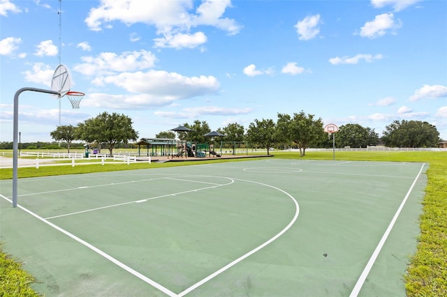 view of basketball court featuring a playground